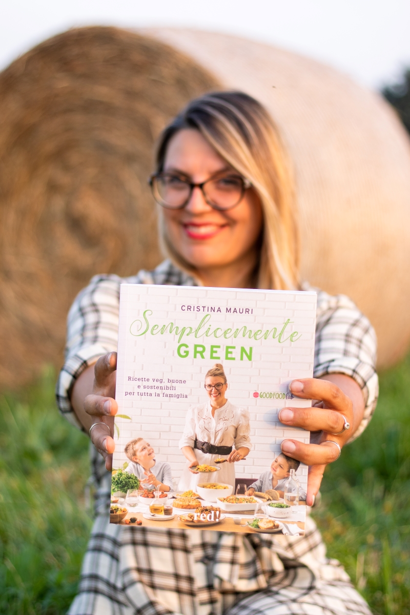 Cristina Mauri holding her Cookbook